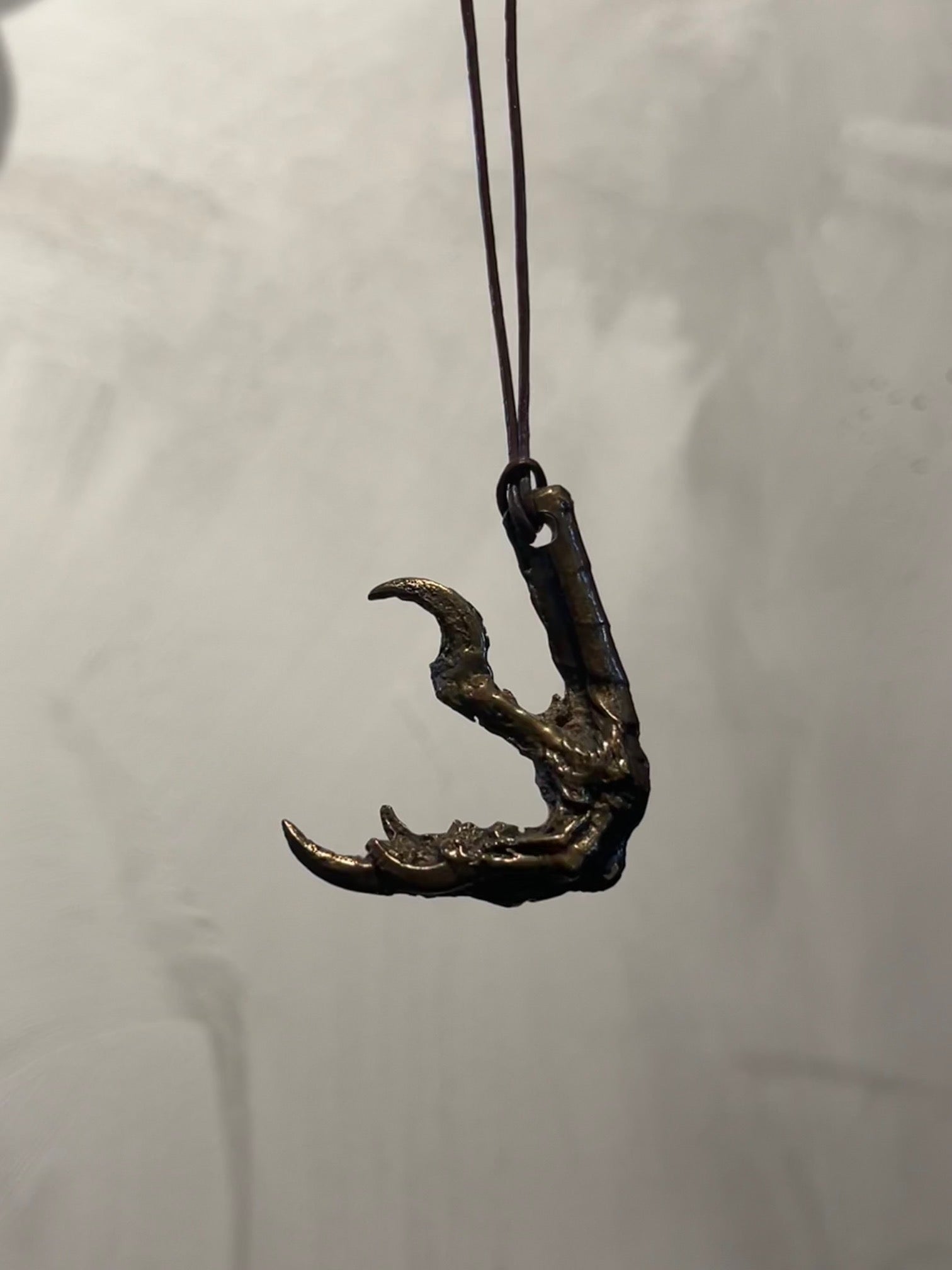 Hand molded bronze CROW CLAW NECKLACE with leather cord